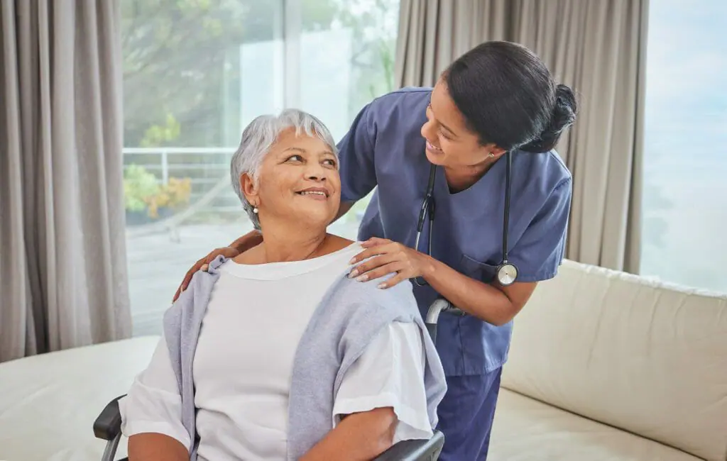 Nurse conducting a comprehensive assessment with a senior patient in a wheelchair